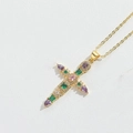 Golden cross necklace with colorful gemstone inlays on white textured background - Gold Purple Zirconia Cross