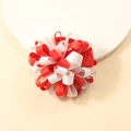 Detail of red and white grosgrain ribbon flower hair tie on a beige background - Red and White