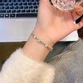 Elegant silver bracelet with white pearls and sparkling zircon flower charm on wrist - S454 Silver
