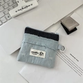 Détail du porte-monnaie en denim avec écusson chien mignon et mousqueton sur un bureau - Bleu Clair Nœud