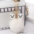 White faux rabbit fur pompom keychain featuring a panda bow and golden metal clip - White - Soft Glue Bow