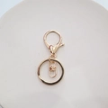 Macro view of gold plated lobster clasp assembly with swivel ring for DIY keychains - Lobster Clasp + Flat Ring + Figure-8 Swivel / Gold Figure-8 Swivel Style