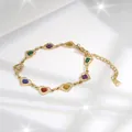 Detail of a gold heart link bracelet with colorful glitter charms and adjustable clasp - Sparkling Multicolor Heart