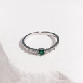 Detail of adjustable silver ring with faceted green zircon and clear side stones - Green Zirconia Platinum