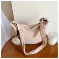 Detailed view of beige corduroy hobo bag texture with matching round coin purse - Khaki