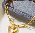 Macro shot of gold paperclip chain bracelet with a heart pendant featuring pavé zircon - Gold Hollow Zircon Heart