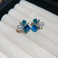 Detailed macro shot of blue crystal flower earrings with pearls on a velvet jewelry tray - Blue (Silver Needle Alloy)