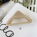 Large triangle hair claw clip in beige minimalist design on a white book aesthetic - Light Nude Pink