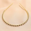 Detail of emerald green cross headband with sparkling black and clear gemstones on gold metal - Black White Gold (FG0009-4)