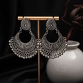 Detail of vintage silver boho earrings with hollow carving and tassels on display - H4416 Antique Silver