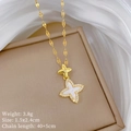 Detail shot of a gold clover pendant with mother of pearl and crystals on a silk cloth - White Pendant (A309)