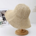 Close-up of beige handcrafted crochet straw hat texture and wide brim detail on wood stand - Beige