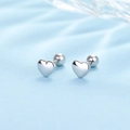 Macro view of silver heart stud earrings with secure screw-back on blue silk fabric - Heart - Silver