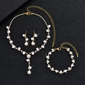 Detailed view of elegant pearl necklace, bracelet and earrings set with gold finish - Gold Artificial Pearl Set