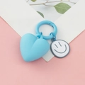 Blue heart pendant keychain with a smiling face charm on a decorative card base - Heart Smiley Face / Blue
