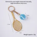 Miniature gold tennis racket and sky blue ball keychain accessory with measurements - 2cm Small Blue Tennis Ball + Gold Racket