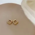Minimalist square golden metal hoop earrings in a geometric and modern design - Gold Square Ear Buckle Pair