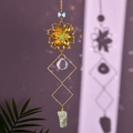 Close-up of golden flower suncatcher showing crystal ball and green natural stone - Green Aventurine
