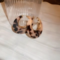Close-up of leopard print resin earrings with gold plating next to textured glass - 2# Ear Buckle - Light Coffee (Real Gold Plated)