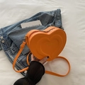 Vibrant orange heart-shaped crossbody bag with gold zipper and adjustable strap - Orange