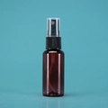 Brown plastic spray bottle with a black nozzle and clear cap on a cyan background - 30ml / Amber Bottle Black Spray