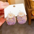 Macro view of purple gradient beaded oval earrings with pearl floral accents and 925 silver pins - Gold-Purple-Flower Cluster Oval