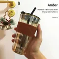 Amber glass tumbler with orange silicone sleeve and black straw for breakfast - Amber + Tea Lid + Black Glass Straw + Orange Silicone Sleeve