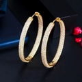 Detail of large 18K gold plated hoop earrings with micro-pave white zircon crystals - Gold