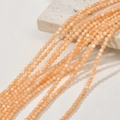 Macro shot of 3mm orange natural shell beads with pearl luster on textured stone - 9# Orange Shell Round Beads / Approx. 126pcs/3-3.5mm