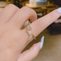 Close-up of golden crystal ring with heart stone and mermaid tail detail on finger - Heart Mermaid Tail Open Ring (SE1068)
