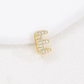 Macro shot of gold-plated letter E pendant with pavé cubic zirconia on white background - E (Single Pendant)