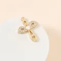 Macro detail of gold-plated cross and bow pendant with heart stone and pavé zircons - Bowknot Cross Style (28#)