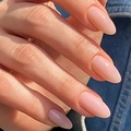 Glossy nude pink almond-shaped press-on nails shown on hand against denim fabric - Glue Type / Almond Nude (Y-297)