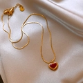 Elegant gold snake chain necklace featuring a glossy red heart pendant on silk background - Gold Red Heart Snake Chain (Titanium Steel)
