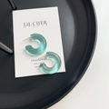Green translucent C-shaped resin earrings on minimalist display for women - Lake Green