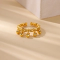 Macro shot of gold open ring featuring braided band texture and hanging bell charms - Adjustable Open / Gold Bell Woven Style (G4127617)