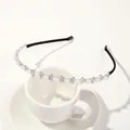 Detail of silver headband with alternating white pearls and rhinestones on a cup - Metal Headband-Pearl Diamond Bowtie