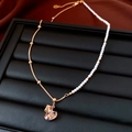 Close-up of vintage heart pendant necklace with zircons on elegant jewelry box display - Necklace-Gold-Multicolor-Heart Style