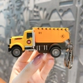 Miniature yellow construction dump truck keychain toy with realistic industrial details - Construction Vehicle Keychain - Dump Truck