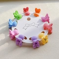 Detailed view of 10 mini rabbit ear hair clips in matte macaron colors on card - Little Rabbit