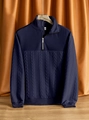 Close-up of dark blue knit sweater with textured geometric patterns and half-zip collar - S / Navy Blue