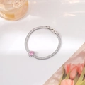 Detail of silver bracelet featuring a pink round stone and sparkling zircon pavé - Silver Round Style