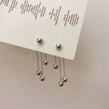 Orecchini a pendente in argento con nappe a sfera e tre catenine lunghe su cartoncino - Argento