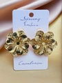 Macro detail of gold flower earrings with petal texture on silk fabric background - 3D Texture Gold Flower Earrings