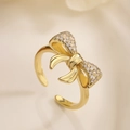 Macro shot of an adjustable gold bow ring with sparkling pavé cubic zirconia details - Adjustable Open / Gold Pave Bowknot