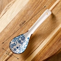 Japanese ceramic soup spoon with blue and white floral pattern on a wooden board - Blue Floral Vine