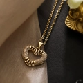 Chic gold-plated heart pendant necklace with shimmering zircon stones on textured fabric - Heart Pendant