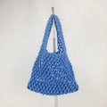 Detail of blue cotton woven beach bag showing intricate crochet hollow mesh pattern - Blue