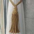 Detail of bohemian cotton rope curtain tieback with handcrafted weave and long tassels - Dark Brown