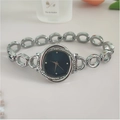 Detailed macro view of a silver women's watch featuring a rhinestone bezel and chain link strap - Silver Blue Dial
